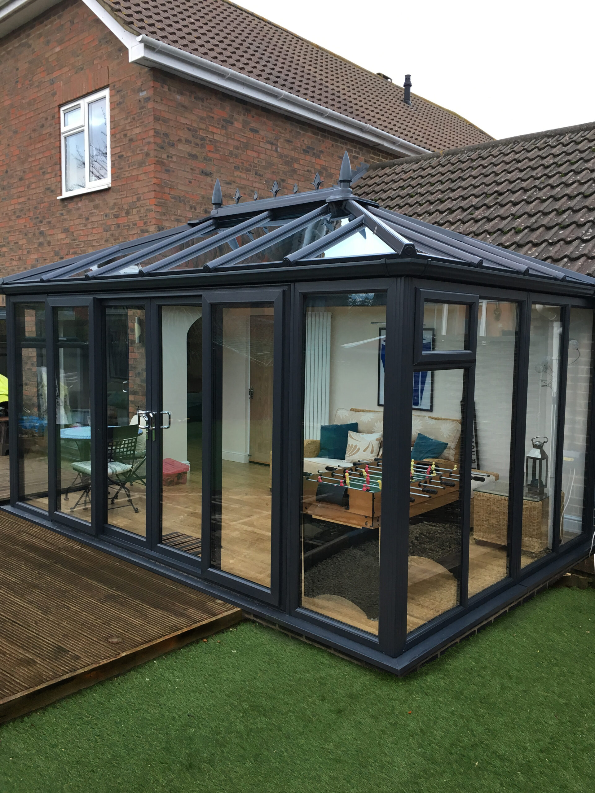 The Edwardian conservatory in a modern anthracite colour with double glazed windows and sliding patio doors in East Sussex.